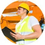 Heavy equipment worker writing on clipboard